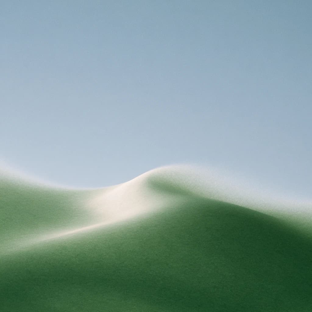 a hill rising into a pale sky